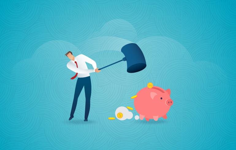 Man hammers the piggy bank