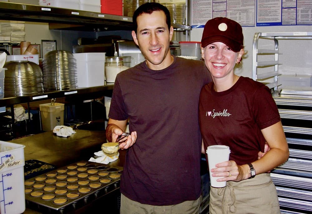 Candace and Charles pour batter in the kitchen of an early Sprinkles location.
