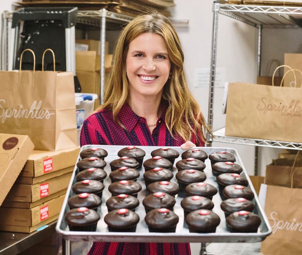 Nelson carries a tray of chocolate marshmallow cupcakes