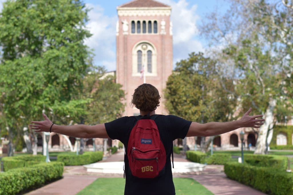 Andrew Kozlovski, wearing a USC backpack, posing on campus. 